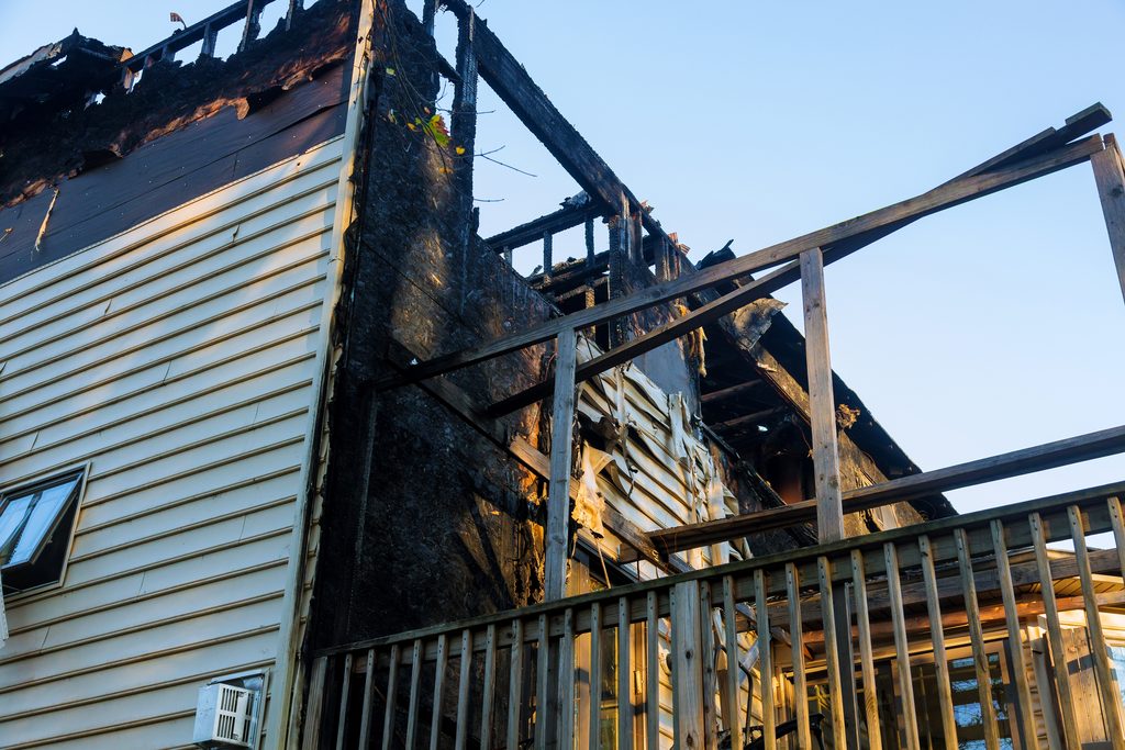 damage to the roof from the fire. the house, completed by siding, suffered from a fire. fire safety