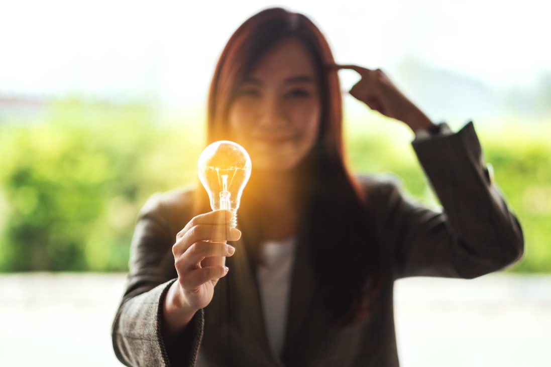 Woman holding a lightbulb