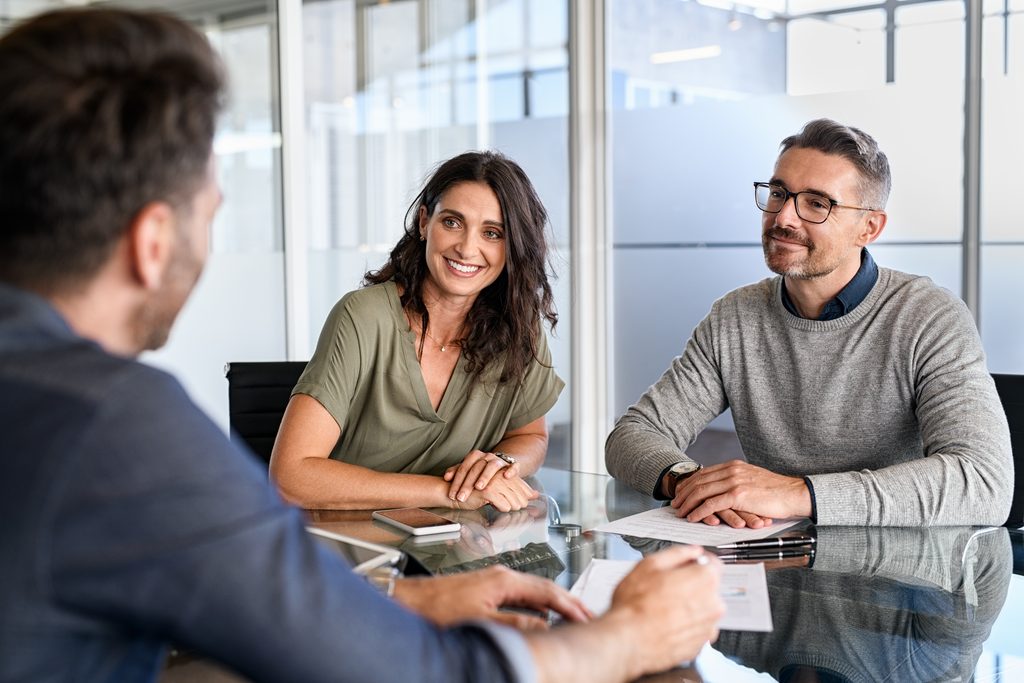 Public adjuster consulting with a couple and answering their questions
