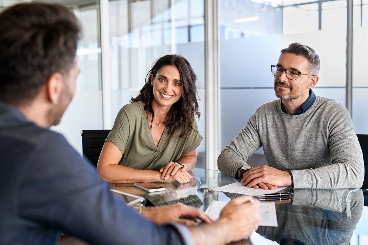 Public adjuster consulting with a couple and answering their questions