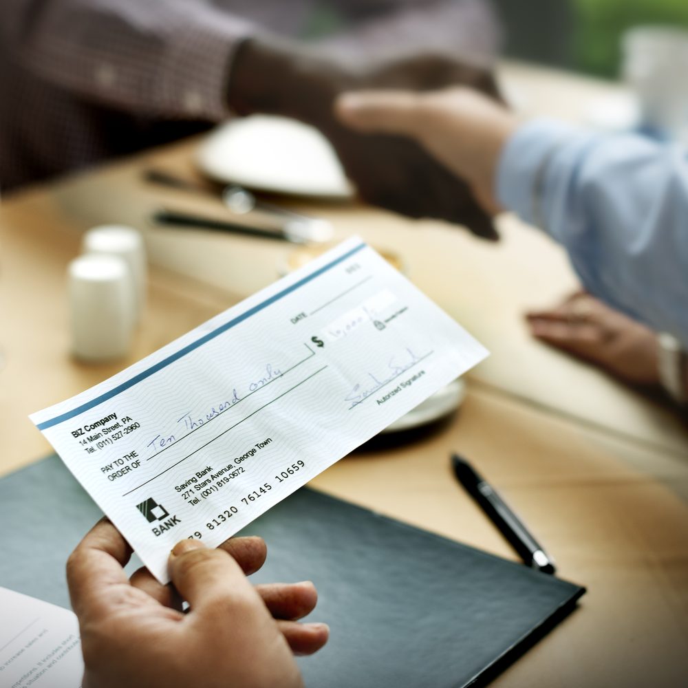 Person being handed a check