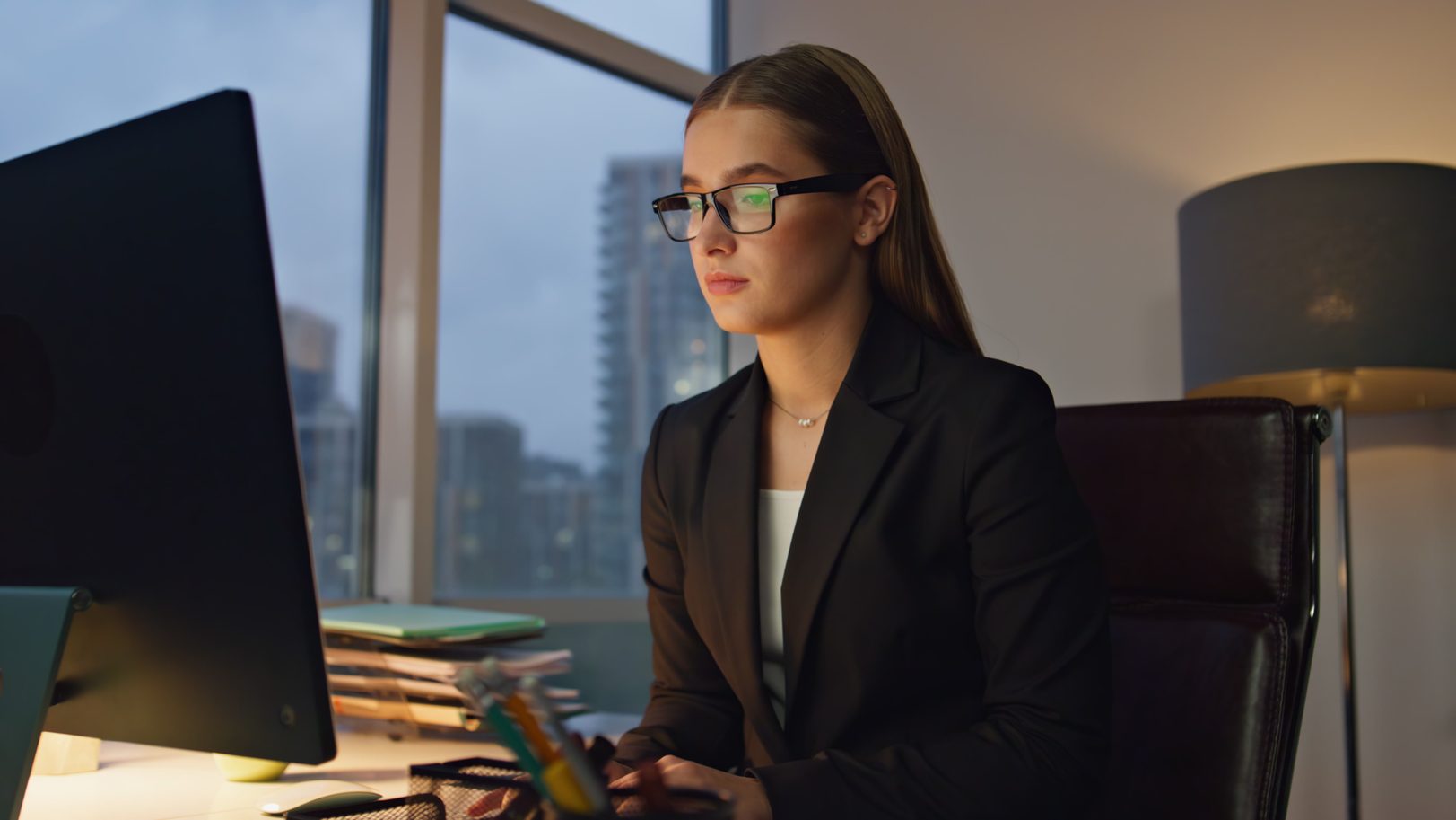 Thoughtful female public adjuster in los angeles in black glasses