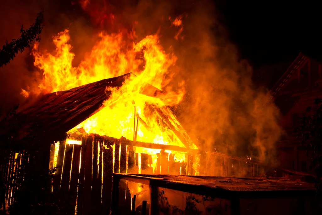 house burning flames smoke rising