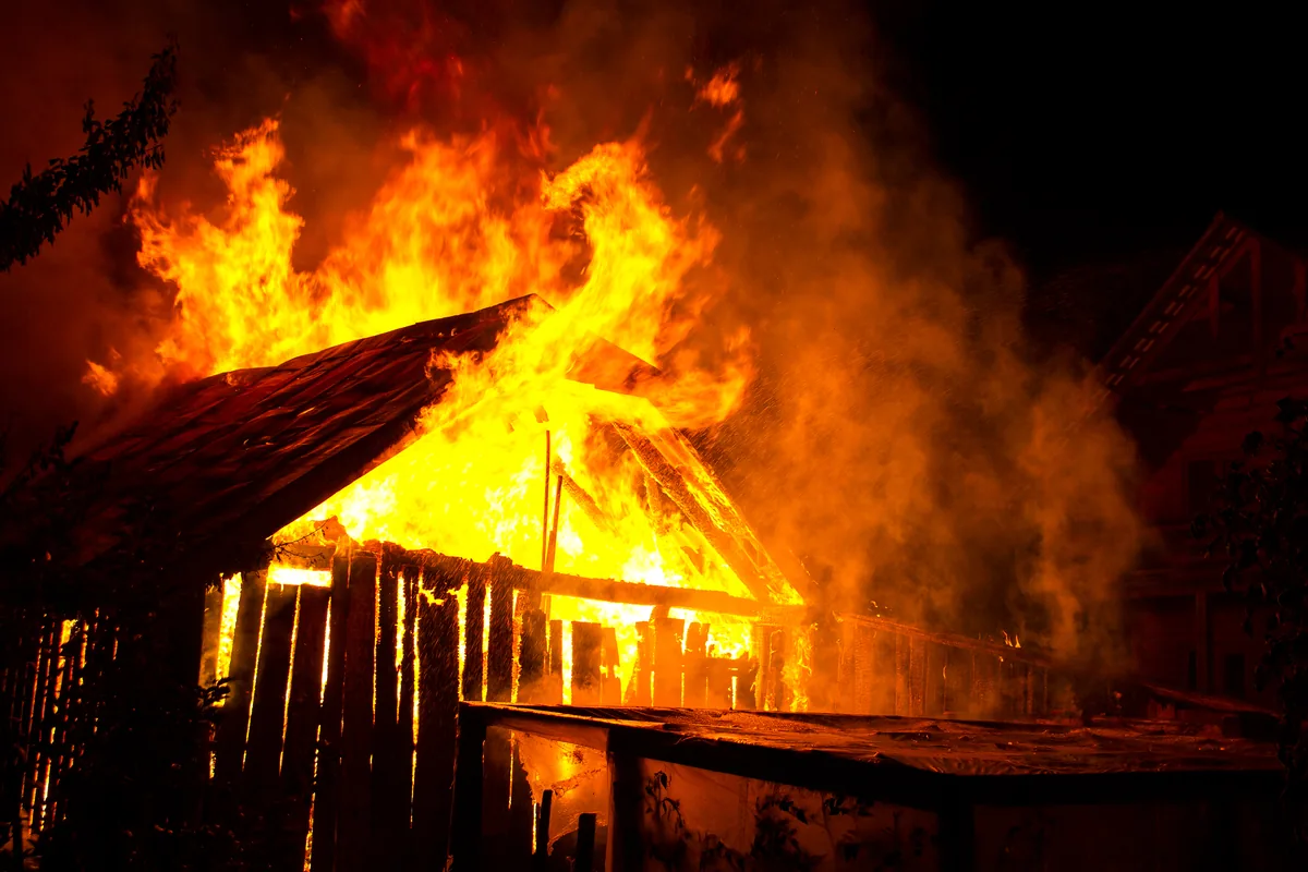 house burning flames smoke rising