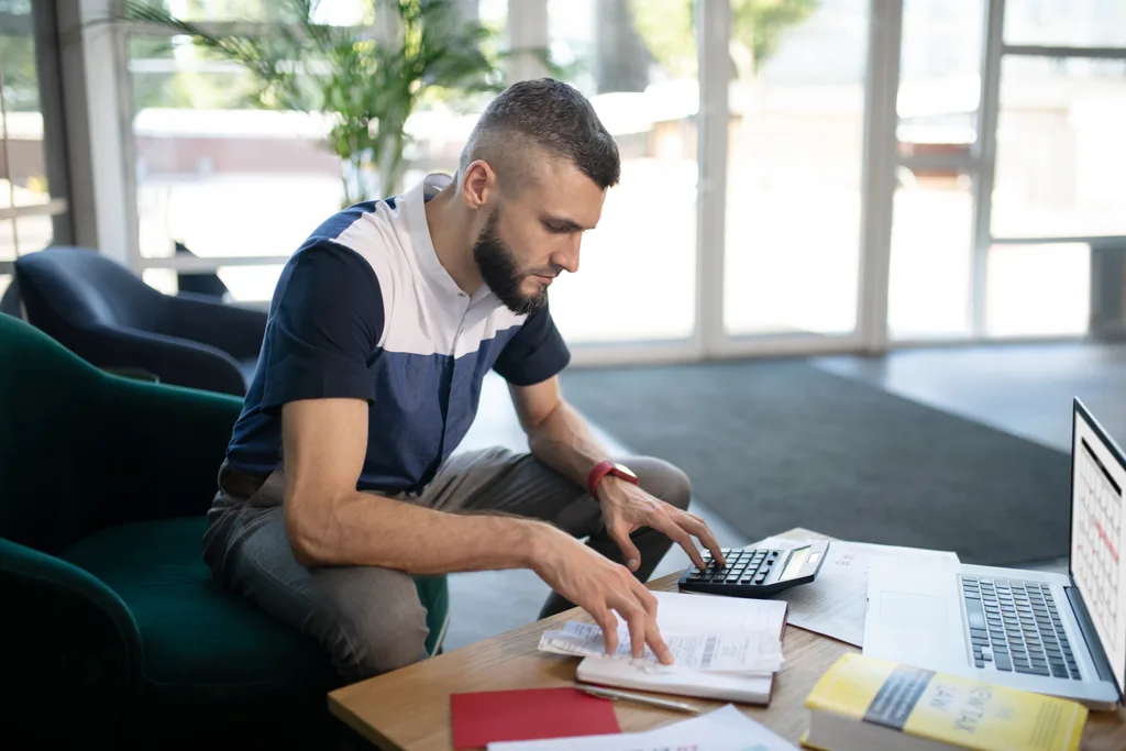 man calculating insurance coverage