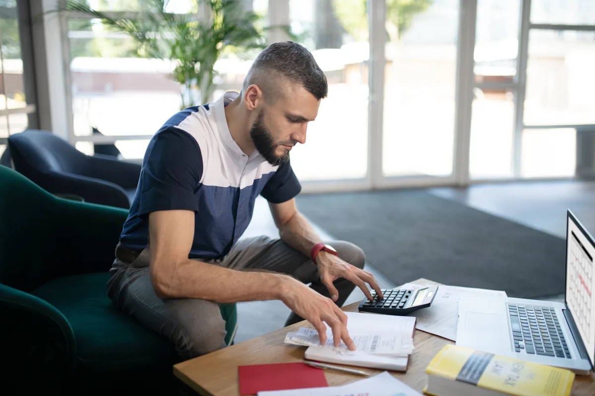 man calculating insurance coverage