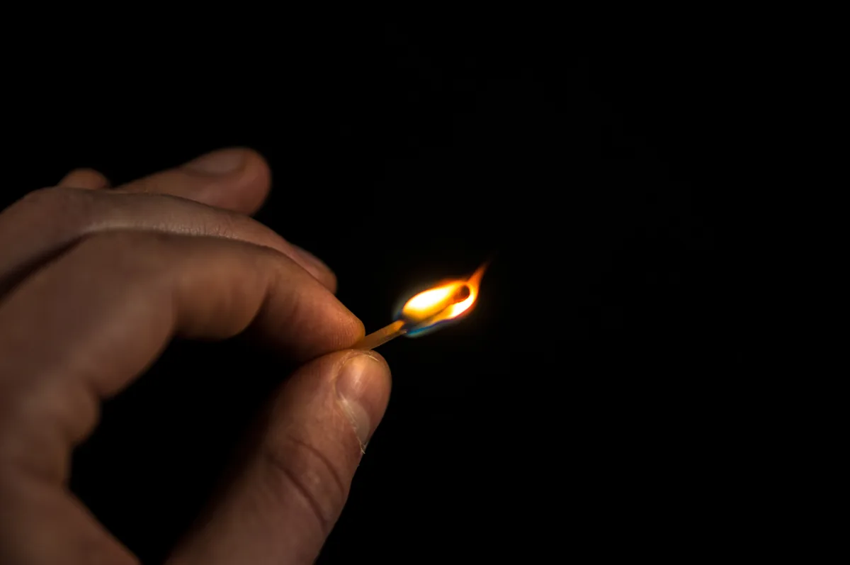 man starting fire spreading