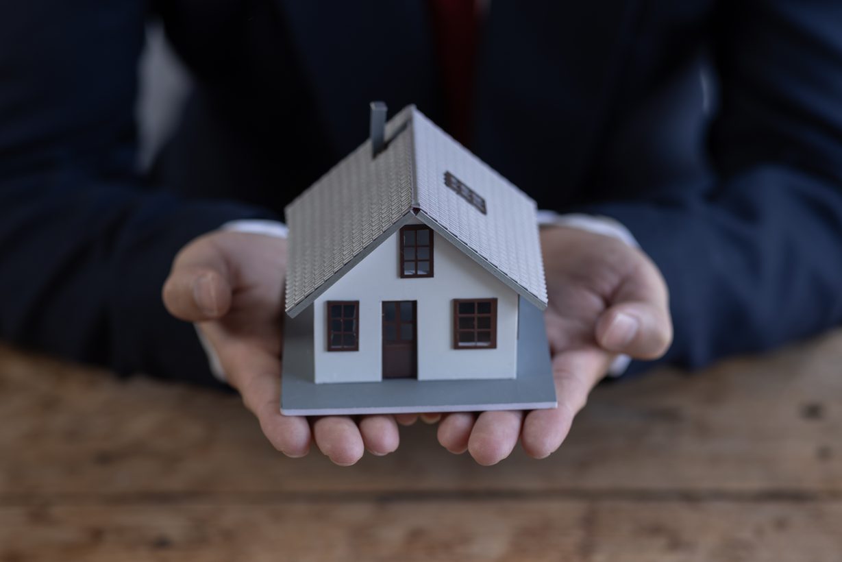 mortgage concept by house from hand
