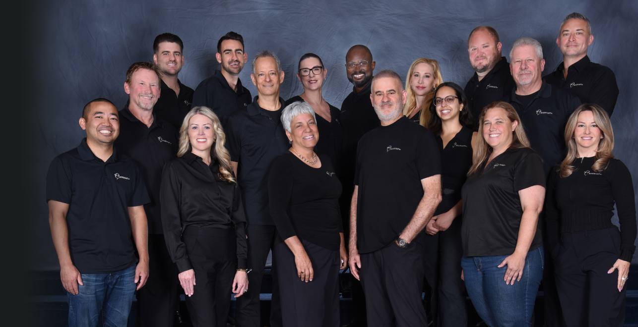 Avner Gat team standing, wearing matching all-black company shirts