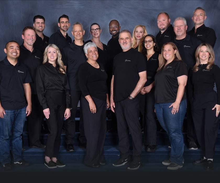 Avner Gat team standing, wearing matching all-black company shirts