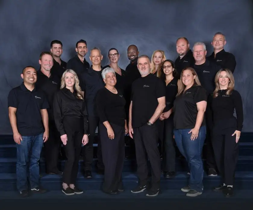 Avner Gat team standing, wearing matching all-black company shirts